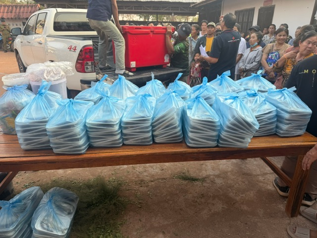 Volunteers organizing food packages for community distribution